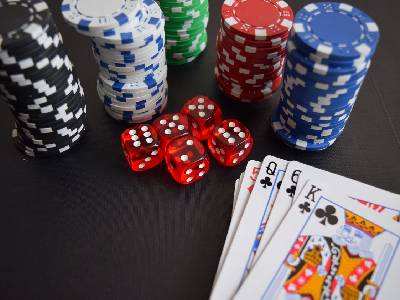 playing cards next to different colored chips and dice